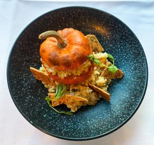a plate of food with a pumpkin on top of rice at The Lincoln Hotel in Lincoln