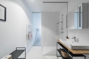 a white bathroom with a sink and a shower at City Sky Studio mit Balkon Vienna in Vienna