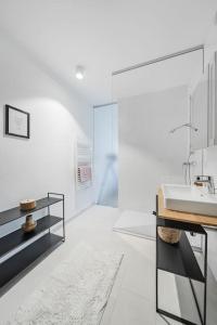 a white bathroom with a sink and a mirror at City Sky Studio mit Balkon Vienna in Vienna