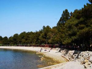 a group of people on a beach near the water at Apartment Crikvenica, Vinodol 3 in Crikvenica