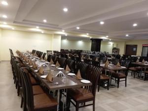 a large dining room with tables and chairs at Hotel Sravasti Residency in Katra
