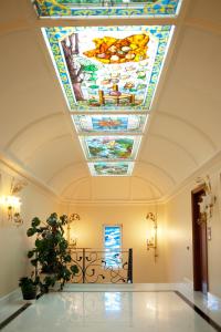 a large room with a stained glass ceiling at Hotel Boutique Edelweiss La Garriga in La Garriga