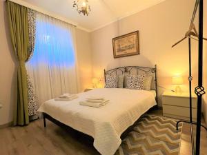 a bedroom with a bed and a large window at New Apartment Near Central Station in Tbilisi City
