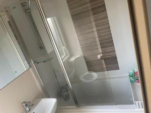 a shower with a glass door in a bathroom at Luxury 6 Berth Caravan, Marton Mere in Blackpool +7 photos