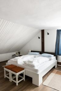 a white bed in a room with a ceiling at Penzion u Hanky in Telgárt