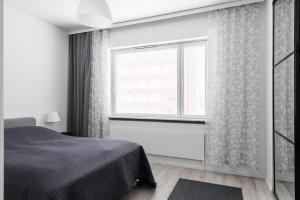 a bedroom with a bed and a window at Fresh 2BR-apartment with FREE parking in Pori