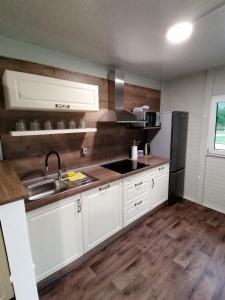 a kitchen with white cabinets and a sink at TOP rafting center in Bovec