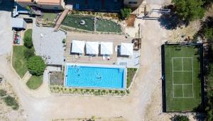 an overhead view of a swimming pool and a tennis court at Camping Vrata Krke in Lozovac