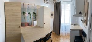 a kitchen with a counter with plants in it at Chez Mary Studio -Jungle et Nature in Gannat