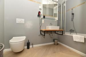 a bathroom with a toilet and a sink at Penthouse Lake Mountains View, lake view, incl SUMMER CARD in Zell am See +14 photos