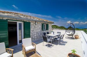 a patio with a table and chairs at Holiday Home Bliss in Splitska