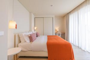 Кровать или кровати в номере White Shell Beach Villas