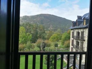 a view of a mountain from a window at Apartamento con jardín y luminoso Besiberri 6 in Pla de l'Ermita