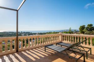 a wooden balcony with a bench and a street light at Villa Bendinat 10 - by Priority Villas in Portals Nous