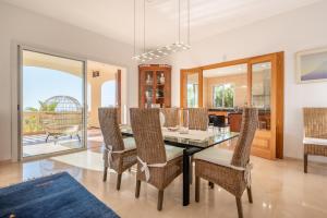 a dining room with a dining table and chairs at Villa Bendinat 10 - by Priority Villas in Portals Nous