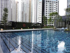 a large swimming pool with tall buildings in the background at AXQUISITE SUITES at KLCC in Kuala Lumpur