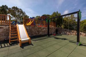 a playground with a slide and a play structure at VILLA AMIRA Porto Cervo con vista Mozzafiato sul Mare,Piscina Privata,WELLNESS & SPA in Liscia di Vacca