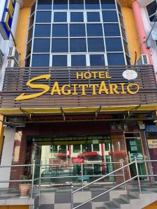 a hotel saatrato sign in front of a building at Hotel Sagittario in Ipoh