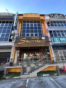 a hotelstaataho is in front of a building at Hotel Sagittario in Ipoh