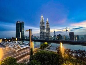 a view of the kuala lumpur city skyline at night at AXQUISITE SUITES at KLCC in Kuala Lumpur +35 photos