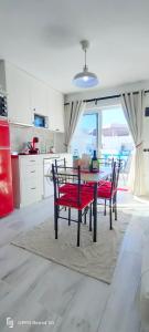 a kitchen with a table and two chairs and a kitchen with a view at RED in Puerto del Carmen