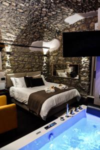 a bedroom with a large bed and a bath tub at Vicolo72 in Calitri
