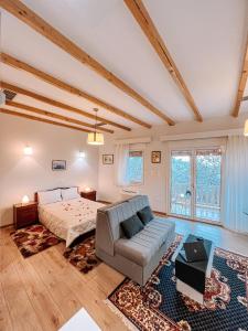 a large bedroom with a bed and a couch at THEA STUDIOS Eurostina in Pírgos