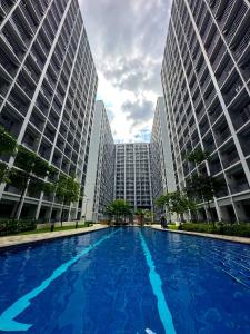 a large pool in a city with tall buildings at Victoria’s Place in Manila