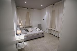 a bedroom with a bed and a table with a lamp at De Luca 6 Apartments in Salerno