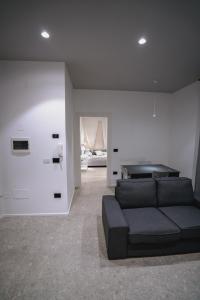 a living room with a black couch in a room at De Luca 6 Apartments in Salerno