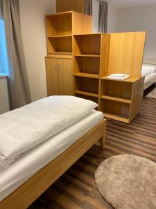 a bedroom with a bed and a book shelf at Apartment Hafingerweg 11/EG in Sankt Pölten