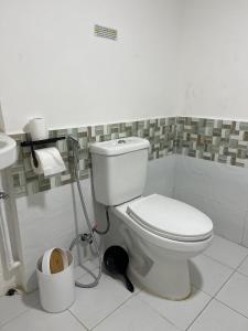 a bathroom with a white toilet and a sink at GCASH - Taal cozy private homestay with PRIVATE attached bathroom in General Trias - Pink Room in General Trias