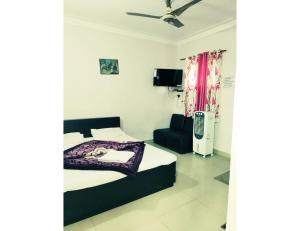 1 dormitorio con 1 cama y 1 silla en Hotel Banjara, Pachmarhi, en Pachmarhī