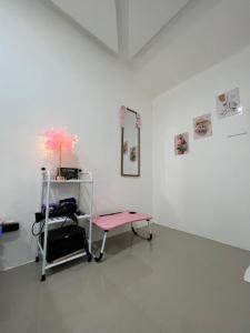 um quarto com uma cadeira rosa numa parede branca em GCASH - Taal cozy private homestay with PRIVATE attached bathroom in General Trias - Pink Room em General Trias