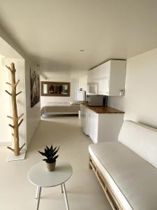 Cet appartement comprend une chambre avec un lit et une table ainsi qu'une cuisine. dans l'établissement LES SUITES LOVE 3 SPA VUE MER PISCINe, à Marseille