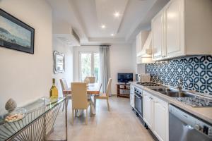 a kitchen with a table and a dining room at Villa Francesca - private pool in Sorrento