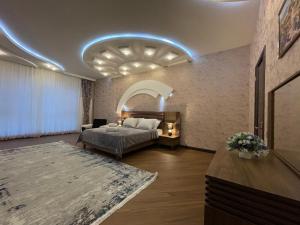 a hotel room with a bed and a couch at Meqafun Sea View apartment in Baku