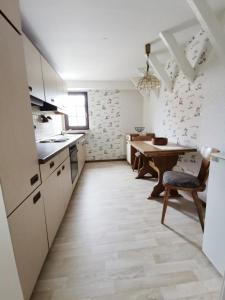 a kitchen with a wooden table and a dining room at Elisabeth Stube in Neuss