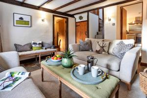 a living room with a couch and a table at Finest Retreats - Ivy Cottage in Casterton