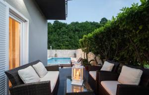 a patio with chairs and a table and a swimming pool at Villa Sierra in Sinj