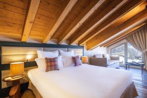a bedroom with a large bed in a room at Les Suites de la Potinière in Courchevel +71 photos