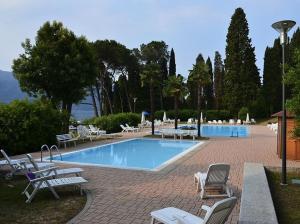 a large swimming pool with chairs at Lavinia in Oggebbio