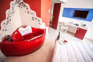 a living room with a red couch in a room at Hotel Oceanomare in Punta Marina