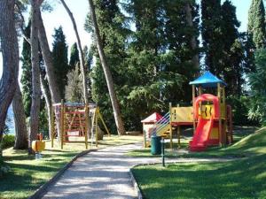a park with many playground equipment in the grass at Lavinia in Oggebbio