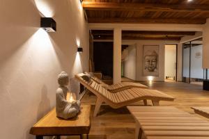 a living room with a statue sitting on a bench at Guest House Valentincic in Nova Gorica