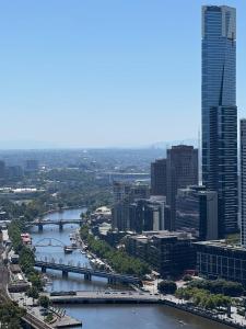 a view of a city with a river and buildings at Pars apartments - Melbourne Quarter- unique View of city and Yarra in Melbourne