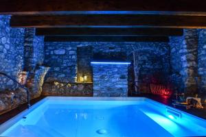 a bath tub in a room with a stone wall at Vicolo72 in Calitri