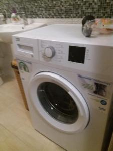 a washing machine in a bathroom next to a sink at Villa Goleš Travnik in Travnik