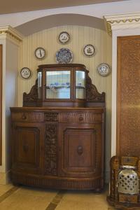 a large wooden cabinet in a room with plates on the wall at Acra Hotel - Special Category in Istanbul