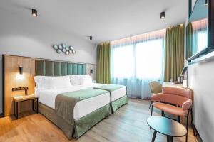 Postel nebo postele na pokoji v ubytování Barceló Budapest